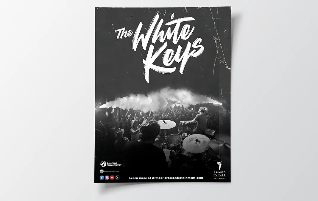 Advertisement featuring the band The White Keys showing the band performing on stage to a crowd of concert goers published by Armed Forces Entertainment.
