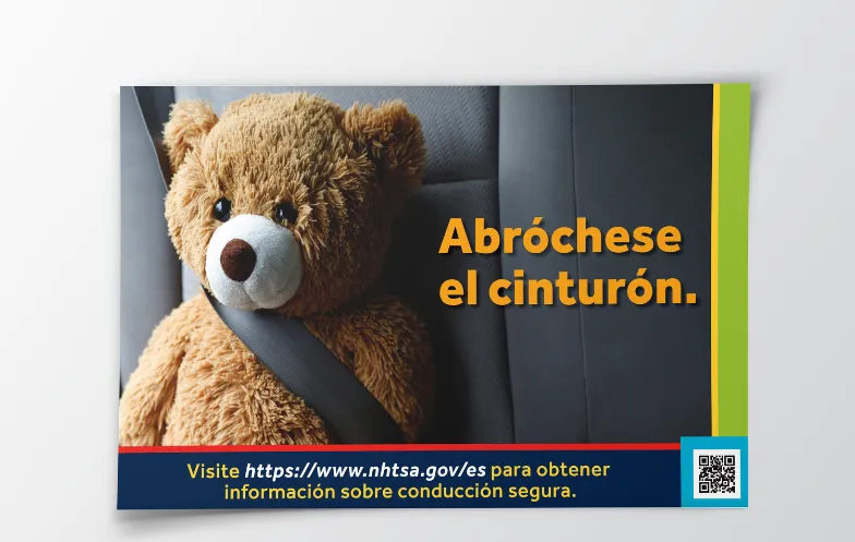 Ad published for the NHTSA Public Health Ad campaign showing a teddy bear buckled up in the backseat of a car with an overlay of spanish text 'Abróchese el cinturón.'