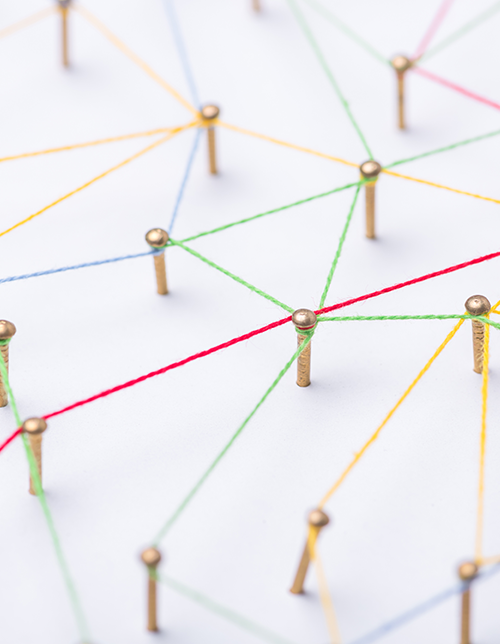 Multicolored strings wrap around pegs, symbolizing connection.